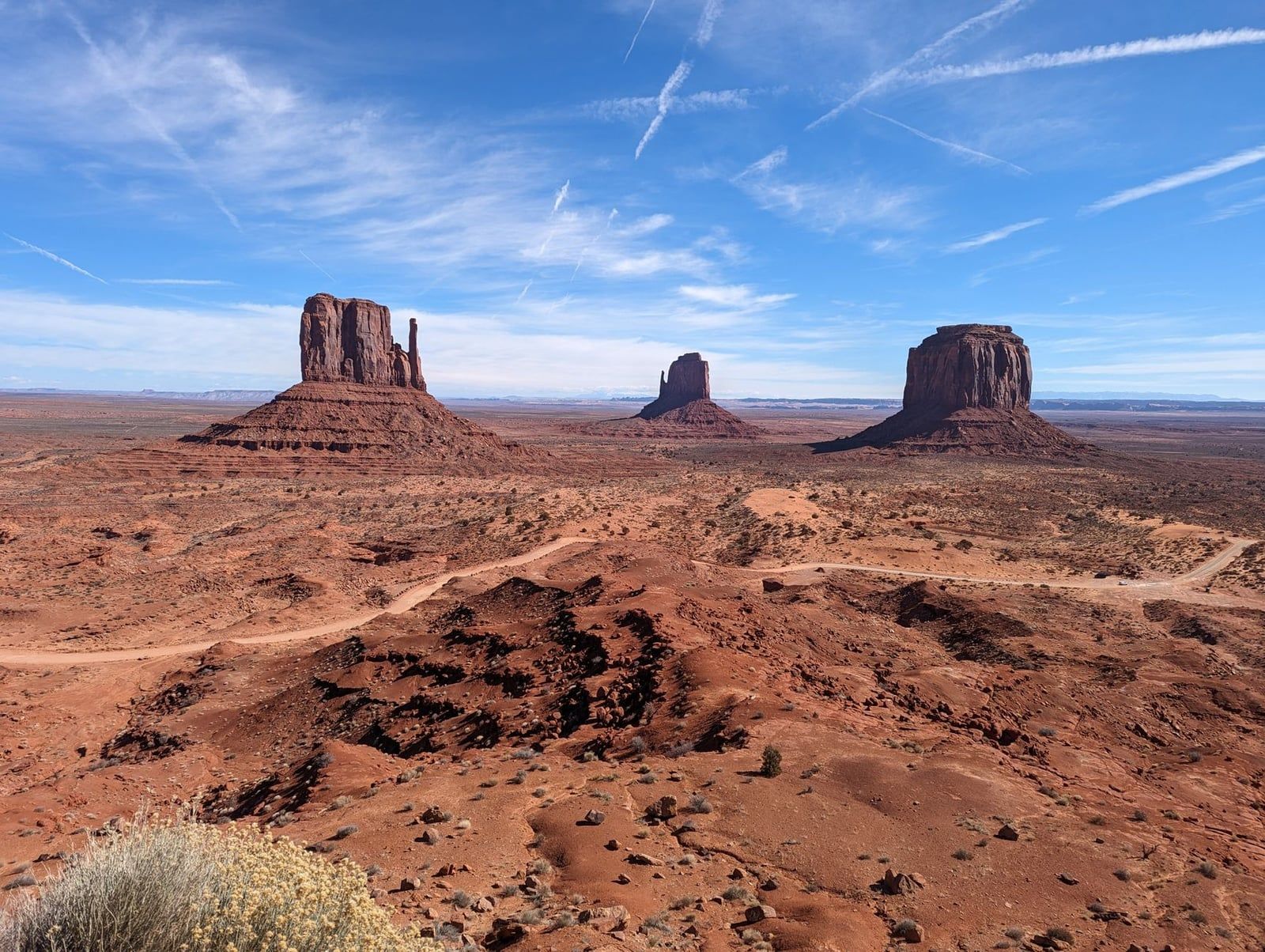 The iconic sandstone buttes of Monument Valley rise across the red desert floor on the Arizona-Utah border.